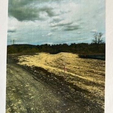 A muddy construction site with cloudy skies above.