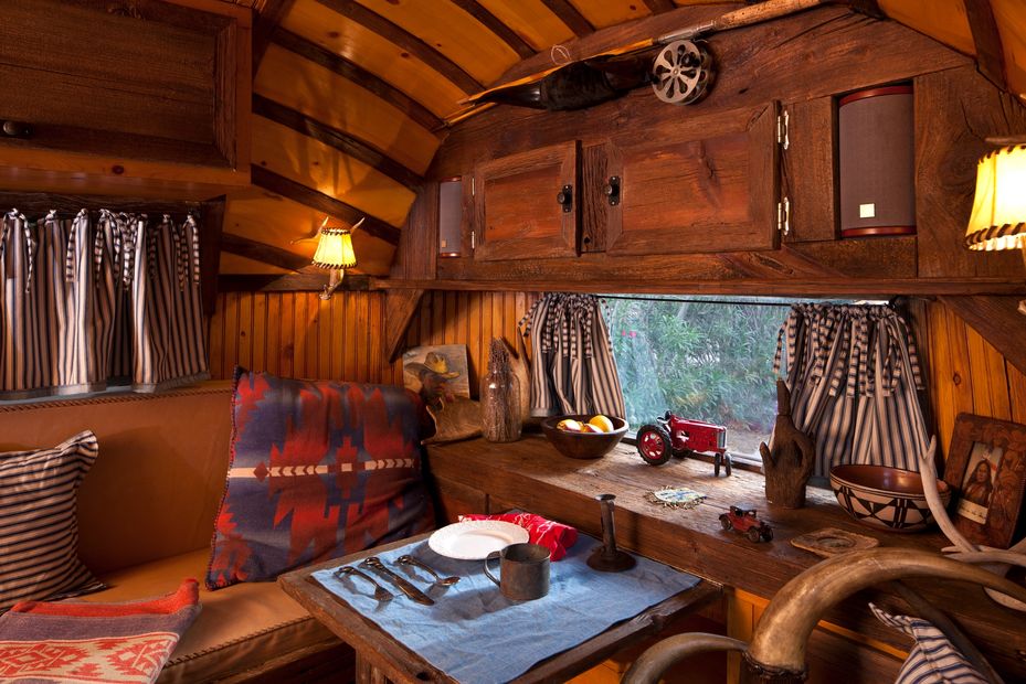 A rustic custom interior of a classic Airstream trailer made to look like the Old West.
