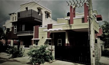 Modern house with unique architectural design and greenery around.