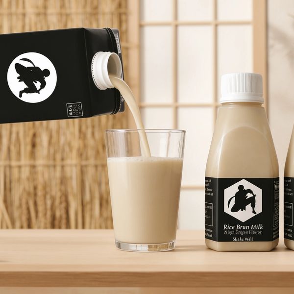 Pouring rice bran milk into a glass with minimalist packaging.