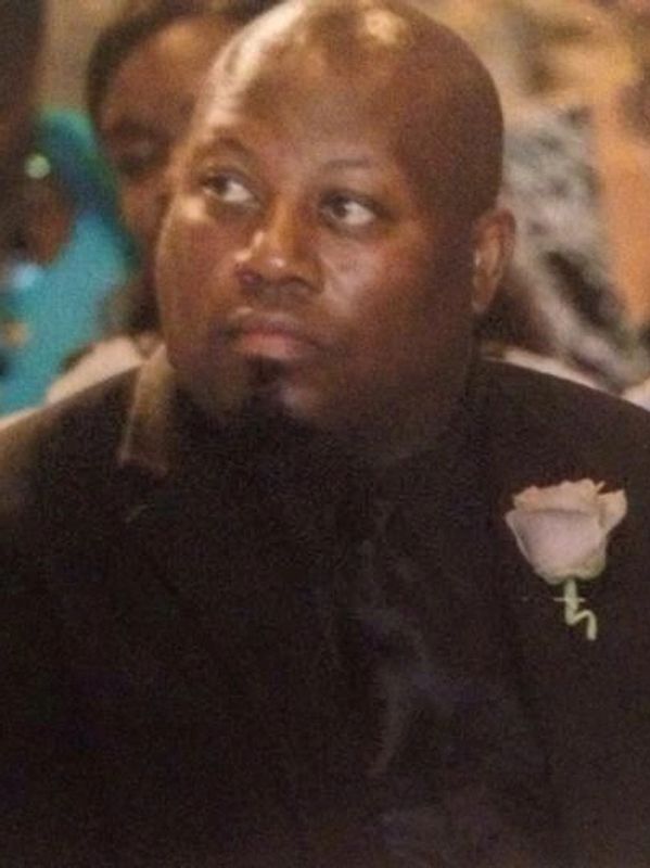 Couple dressed formally, attending an event with serious expressions.