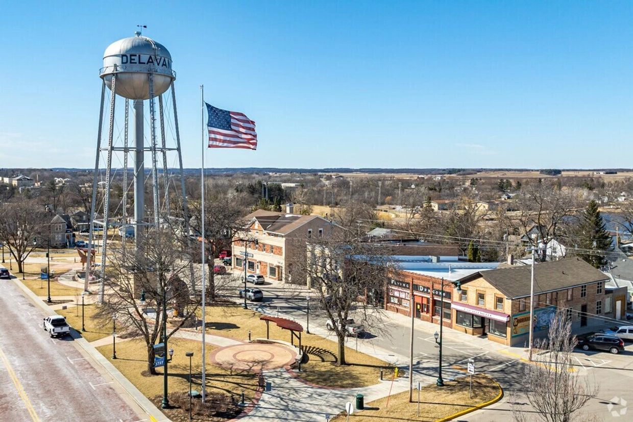 Historic Delavan water tower overlooking downtown Delavan, Wisconsin, with local streets, commercial buildings, and the surrounding community.