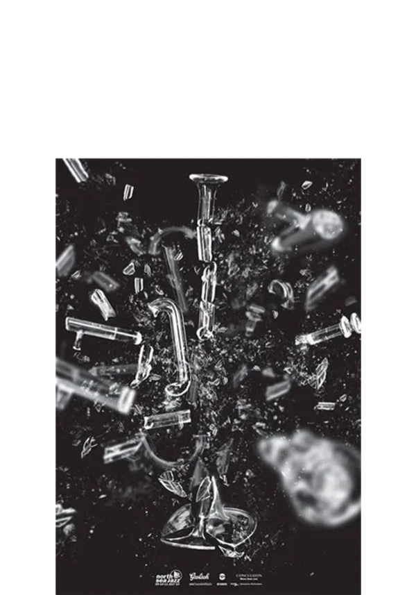 Shattered glass pieces explode outward in a dynamic black background.