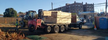 Truck loaded with wooden crates at a construction area.