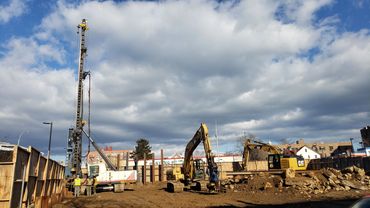Construction site with heavy machinery and blue sky.