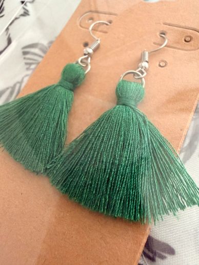 Handcrafted with colorful macramé string, these earrings bring an organic charm to any look. Each pa