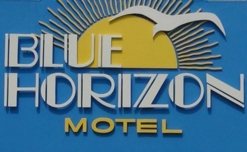 Signboard for Blue Horizon Motel with sun and bird graphics.