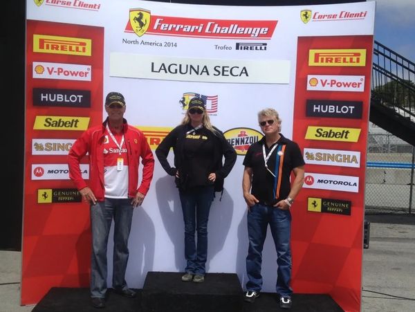 2 Men and a Woman standing on a podium at Laguna Seca