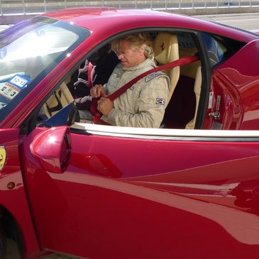 Blonde man sitting in Ferrari