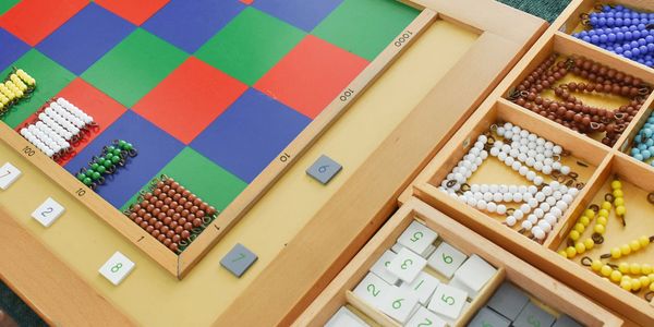Montessori Checkerboard with bead bars and number tiles. 
