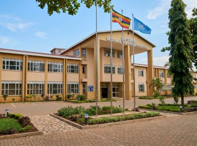 Building with flags and well-maintained garden