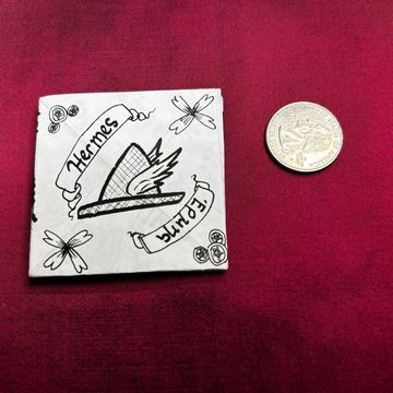 Small black and white sketch with Hermes and Equina text, next to a coin.