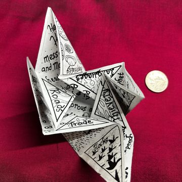 Handmade paper fortune teller with writings and drawings.