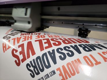 Mimaki printing Adhesive Vinyl for window graphic installation.