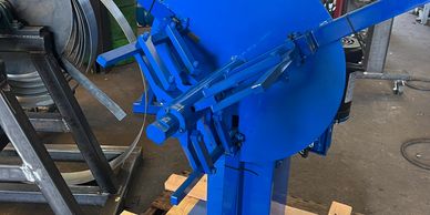 Blue industrial metal machine part.