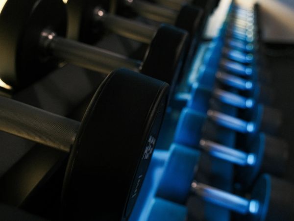 Set of weights and dumbbells in a semi-private, group training gym located in Victorville, CA