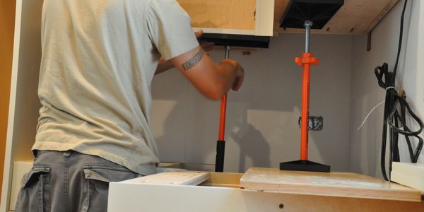 The lightweight, multi-purpose  T-JAK® kitchen cabinet installation jack, hang cabinets alone