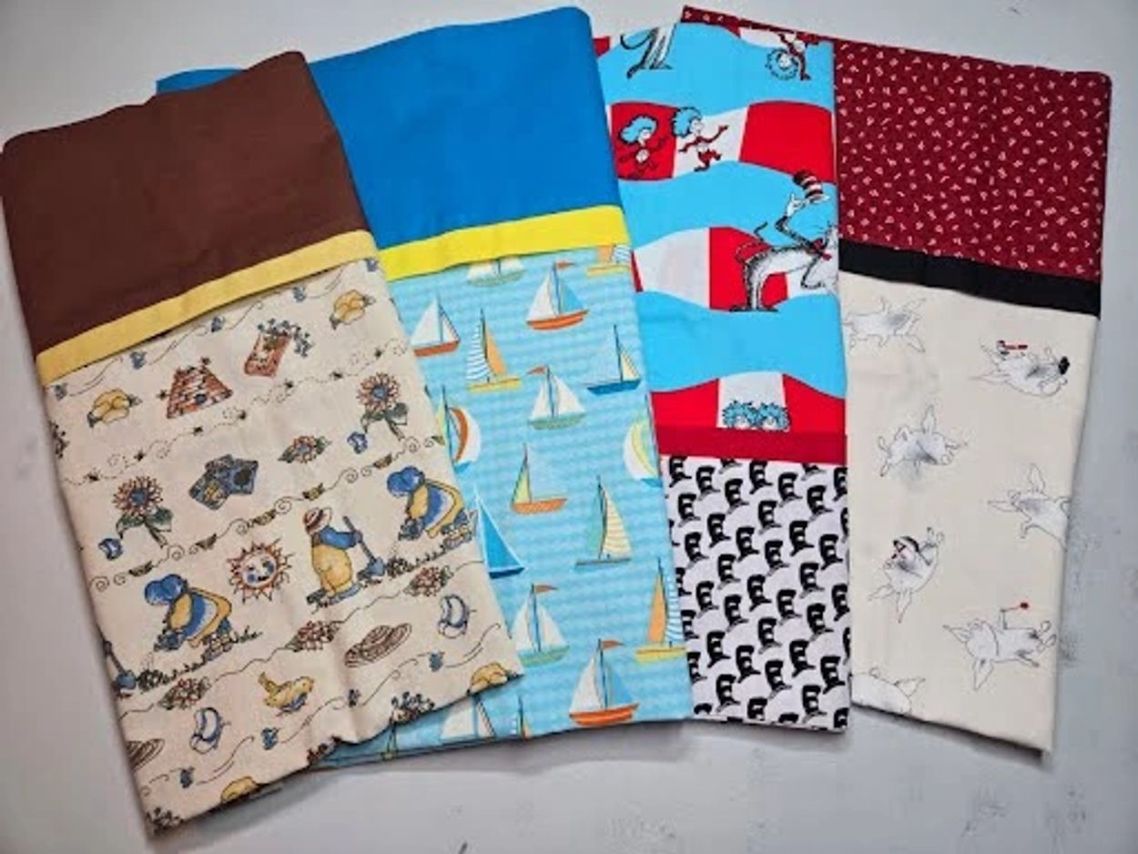 Four colorful fabric pieces with different patterns and borders.