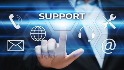 Business professional interacting with digital support icons on a virtual screen.
