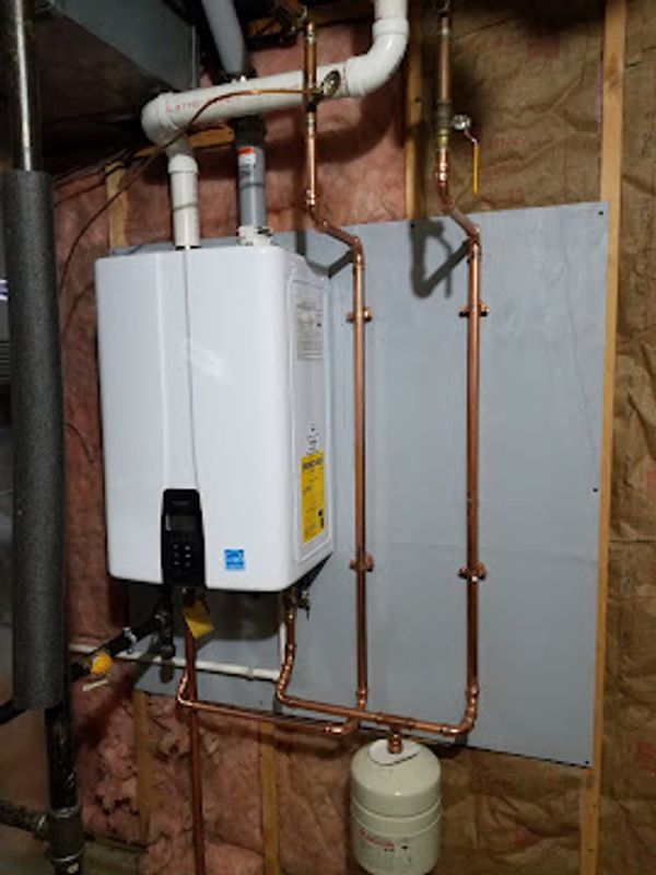 Tankless water heater mounted with clean, organized run piping.