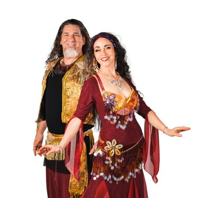 Couple in colorful traditional dance costumes posing and smiling.