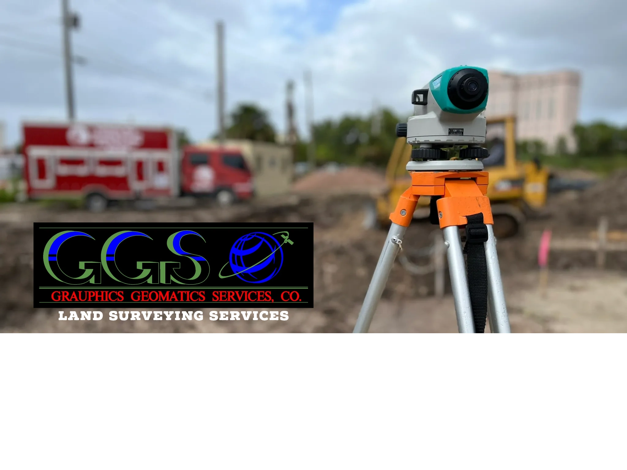 A surveying instrument on a tripod at a construction site with a company logo & land surveying text.