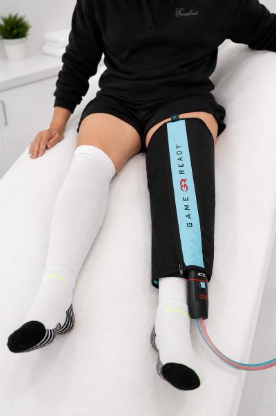 Person using a compression therapy leg sleeve.