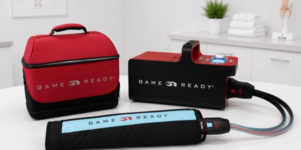 Game Ready cold therapy device with carrying case on a table.