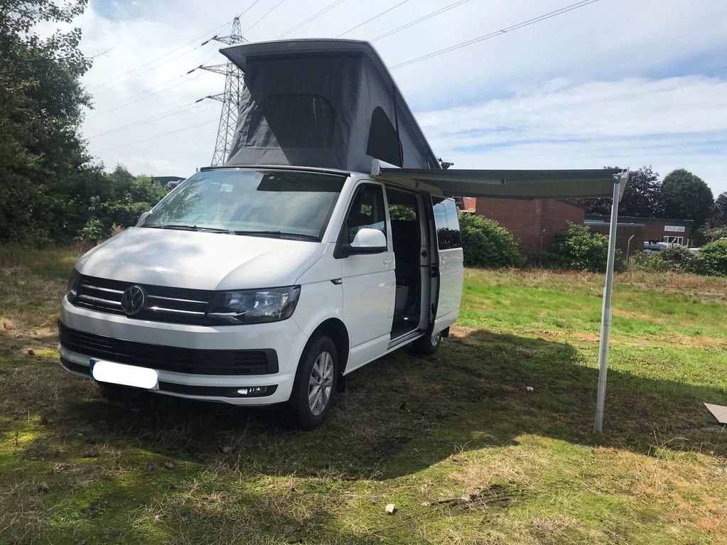 White Volkswagen Transporter campervan conversion with Reimo elevating roof 