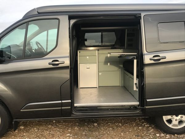 Ford Transit Custom campervan conversion with SCA elevating roof and pale green interior units 