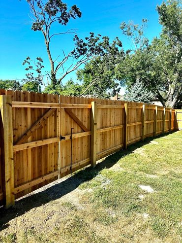 cedar 2x4s and cedar privact fence with a gate