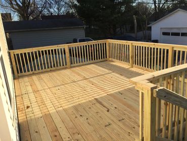 custom treated deck floor with a treated handrail.