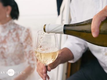 Martha's vineyard wedding champagne toast aboard a sailboat