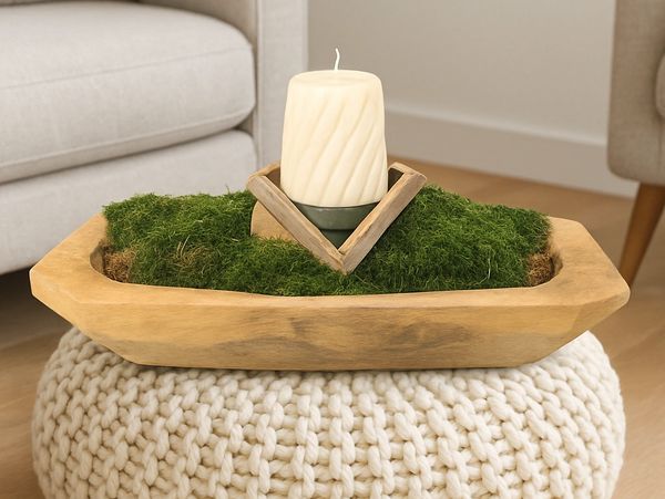 Wooden bowl, filled with green moss, holds a geometric wooden holder.