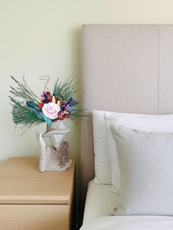 A sculptural vase adorned with preserved flowers and forever rose. moss cyprus