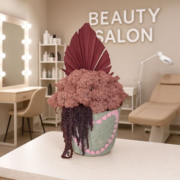 Pot decorated with pink hearts holds a fluffy moss, amaranthus, and a large, dried burgundy palm lea