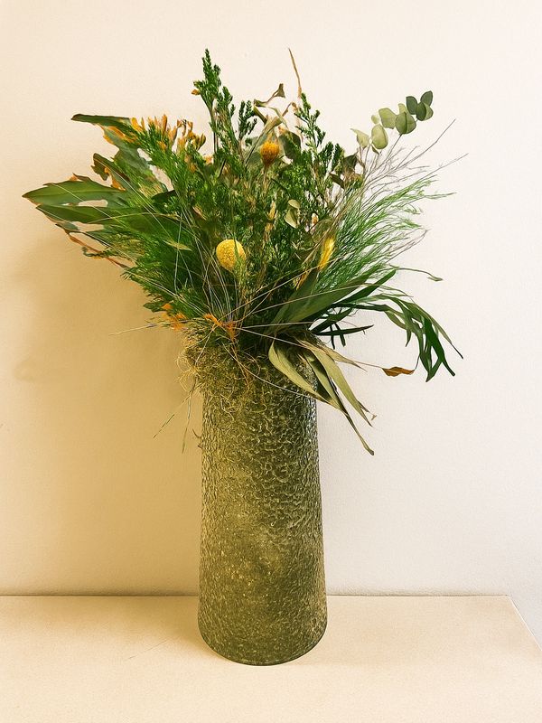 Glass vase with preserve green bouquet