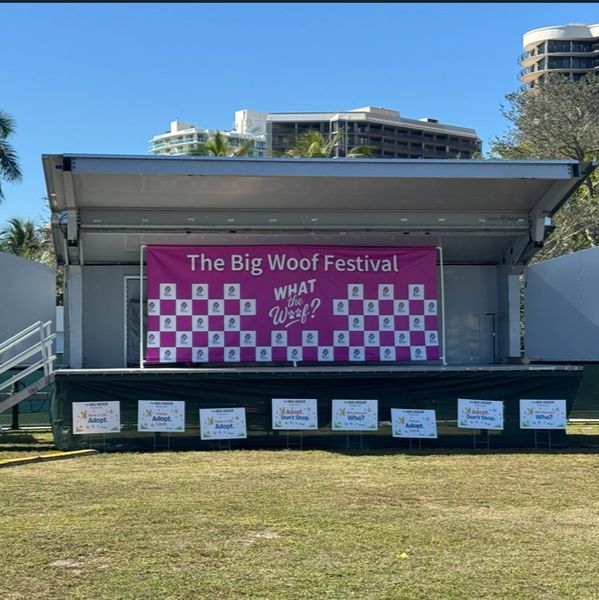 Empty stage at The Big Woof Festival with event banners.