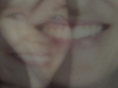 Superimposed and faded images of two smiling women. This is a video still from the documentary.