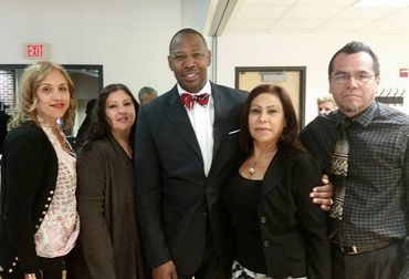 Graduation is important to the entire family. Dr. Sewell takes a photo with a student's family.