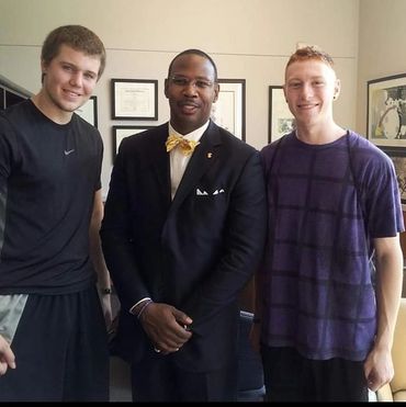 Dr. Sewell, being student-centered, chats with a few students during his open-door period.