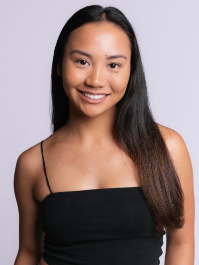 Smiling woman with long hair in a black top.