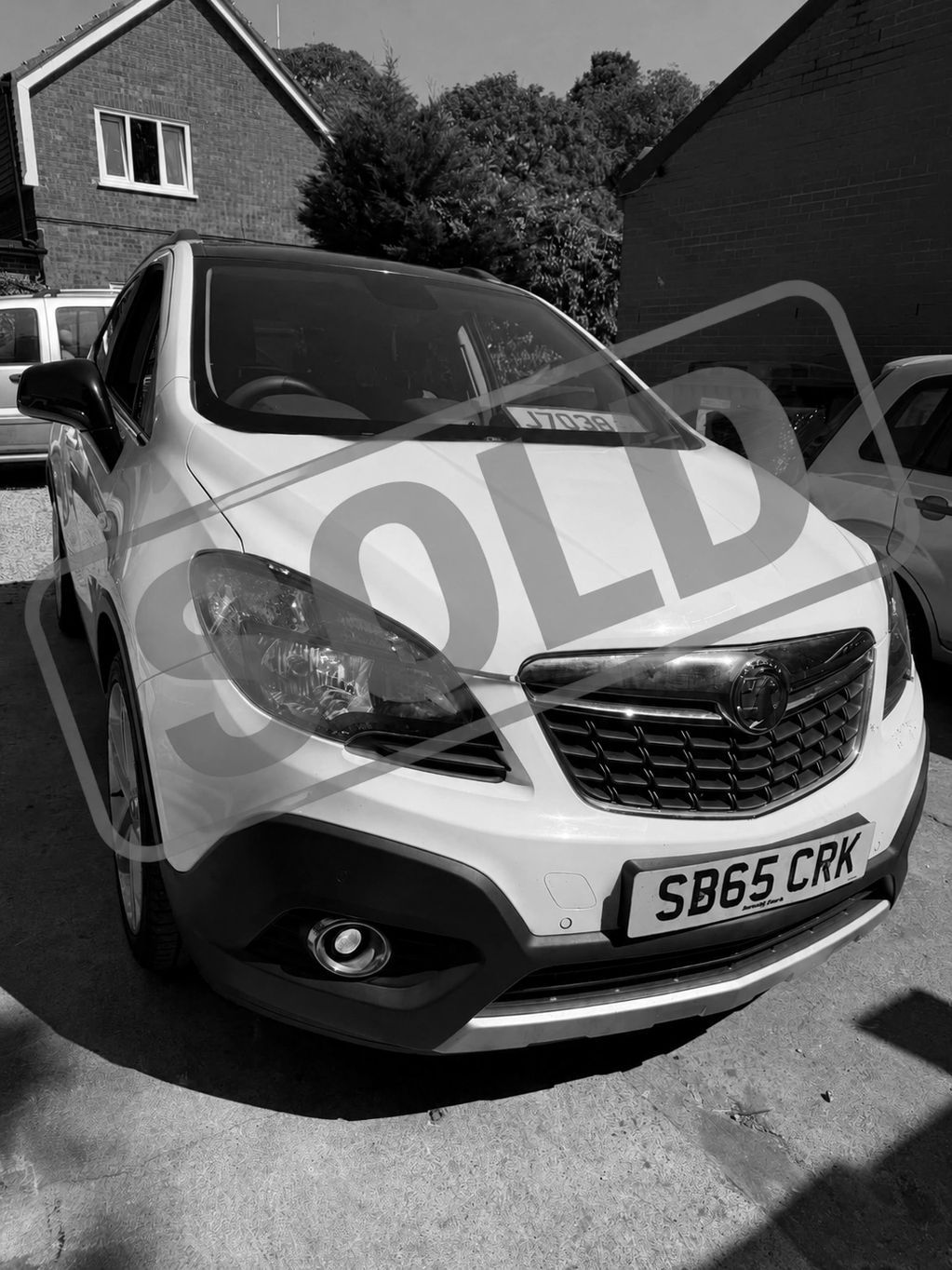 White Vauxhall car with SOLD sign on windshield.