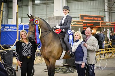 national champion rider with her parents and trainer