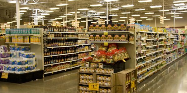 Grocery store aisle with various food items and signage.