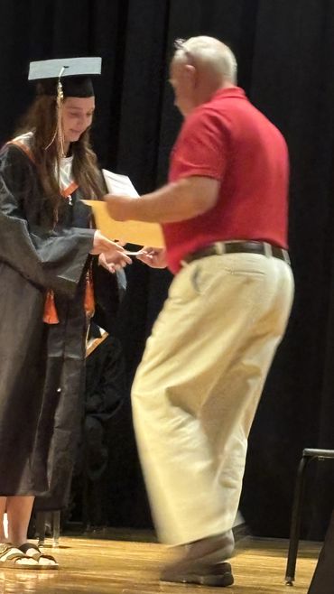 Emiyn Robertson of Bath County High School receiving the scholarship from Mike Dabbs President of Ka