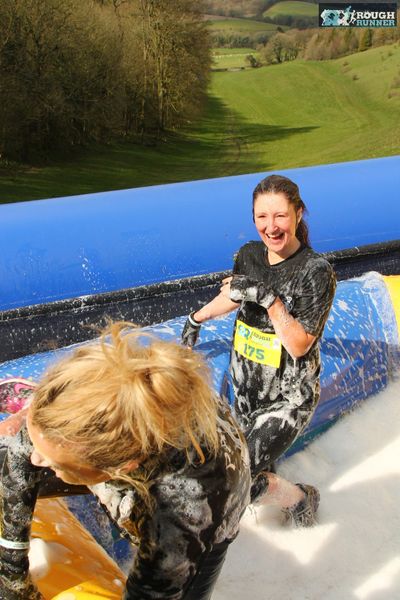 Massage therapist and owner of Naturally Serene Justine in bubble slide at rough runner