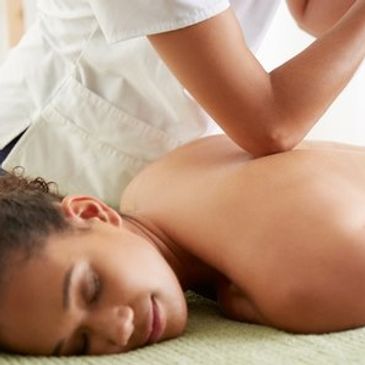 Lady with back and neck pain having deep tissue massage