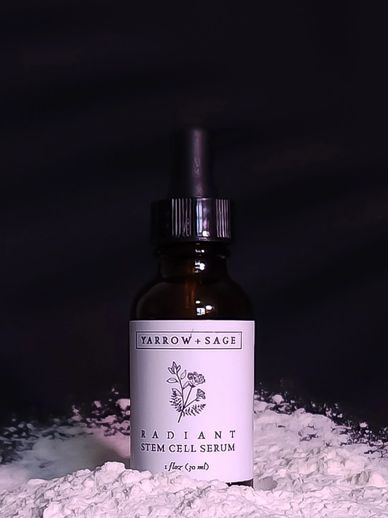 Radiant stem cell serum in an amber bottle on a black background