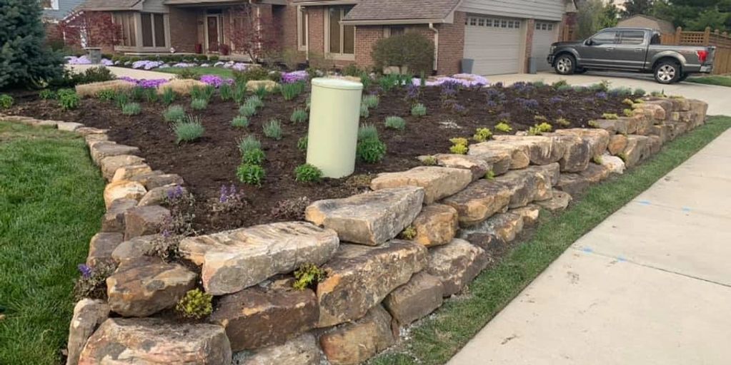 Boulder wall with complete perennial layout for color all summer long!
